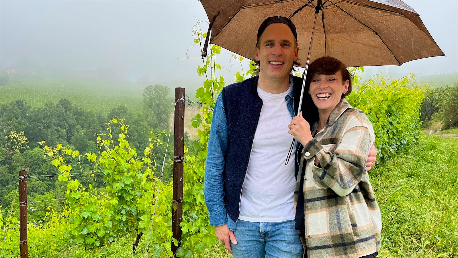 Carlo Mondavi and Giovanna Bagnasco under an umbrella in their Sorì della Sorba vineyard.